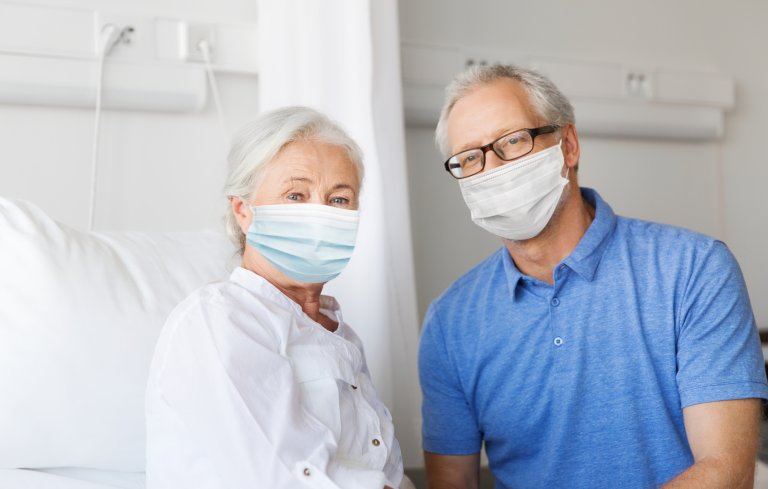 37227886-senior-couple-in-face-masks-meeting-at-hospital-Mostphotos.jpg
