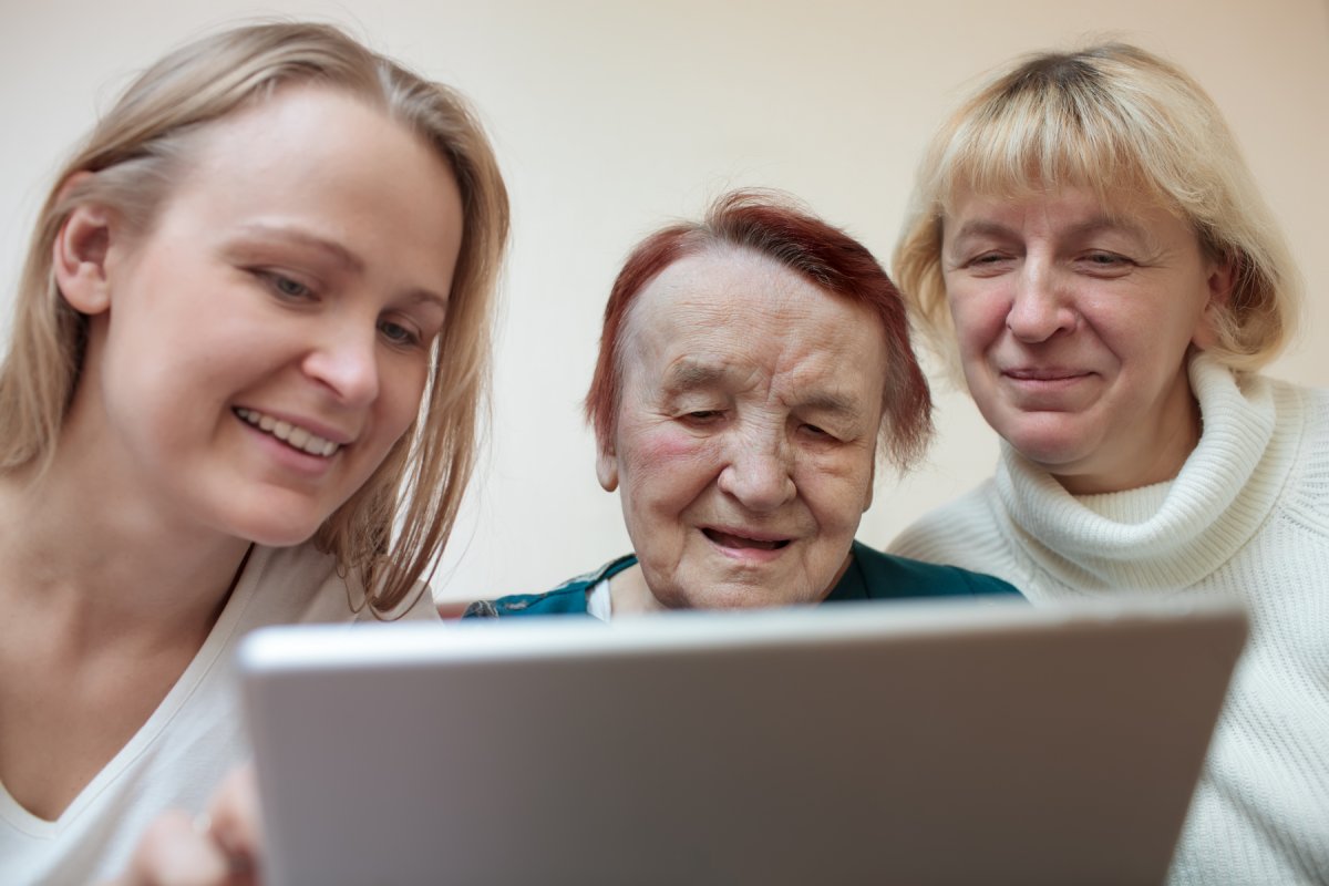 Three women using tablet