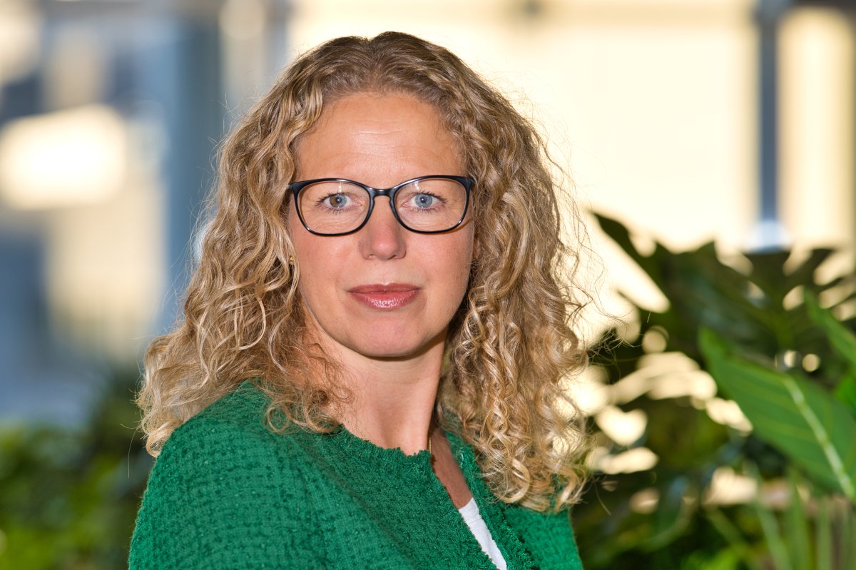 Kvinne med grønn jakke og briller